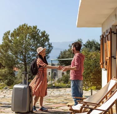 Host welcoming a guest at a vacation rental, enhancing Airbnb and VRBO listings