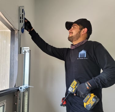 Alex with On Point Overhead Doors repairing a garge door in Kyle TX