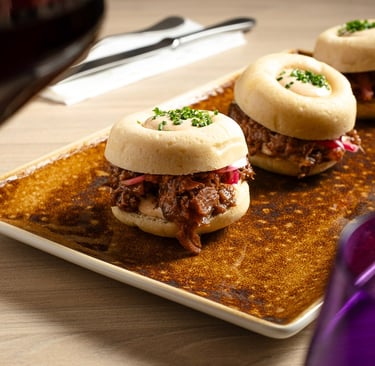 a plate of food and wine glasses on a table