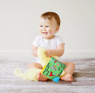Baby holding My 1st Arabic Number Book by Desi Doll
