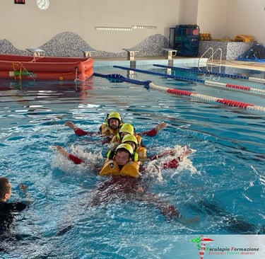Water Rescue Drill – HEMS trainees practicing water rescue techniques in a controlled pool exercise.