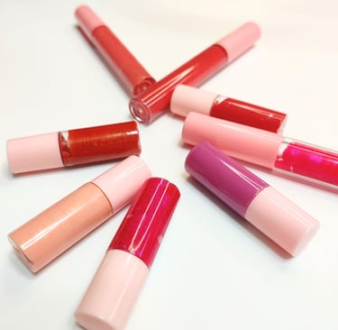 handmade lip glosses laying flat on a white table