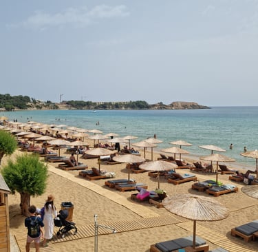 a beach with many lounge chairs and umbrellas