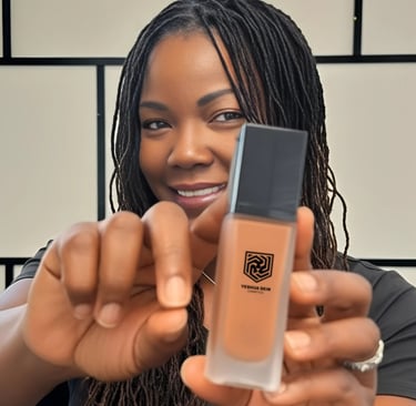 A woman holding a bottle of Yeshua Skin liquid foundation for dark skin tones.