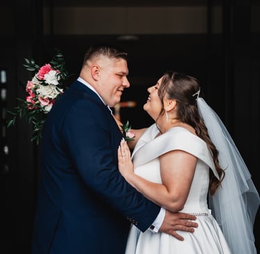 a bride and groom standing in front of a doorway