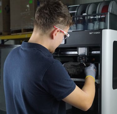 Unser Techniker bei der Wartung einer FDM-Anlage vor Ort.