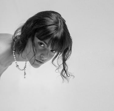 Model wearing a fun.arc.ik. classic pearl necklace, captured in a close-up black-and-white portrait.