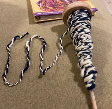 A beginner attempt at plying wool on an Ashford student spindle