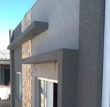 Casa con revestimiento texturado a llana RULATO