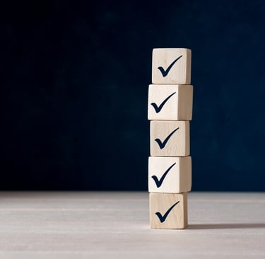 A stack of wooden blocks with tick check marks on them
