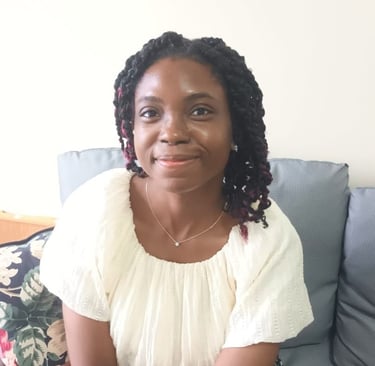 woman smiling with grey chair background