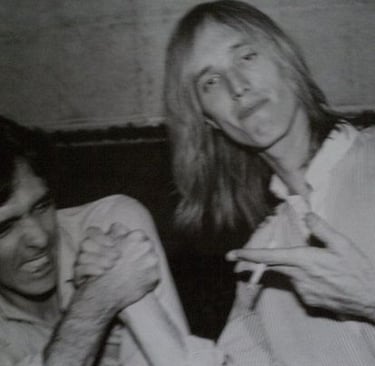 Charlie Kendall arm wrestling with Tom Petty.