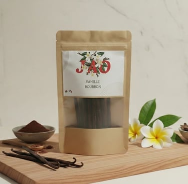 Package of Vanille Bourbon pods on a wooden board with vanilla beans and plumeria flowers. JAO