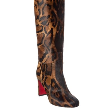 a woman's Christian Louboutin leopard print boots with a leopard print