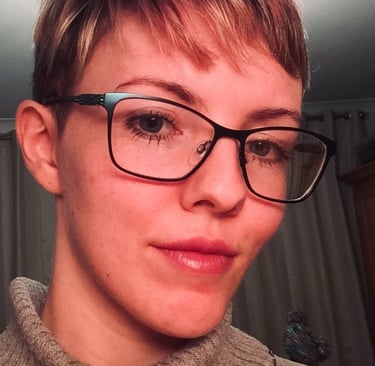 Trans masculine person pre-transition and femme presenting in makeup