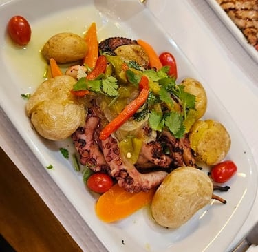 a plate of food and a glass of beer on a table