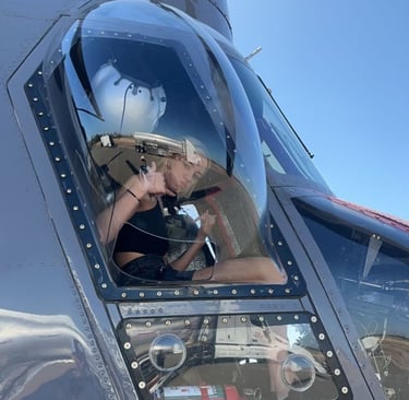 Woman in helicopter cockpit, embracing bold travel adventures and life transformation