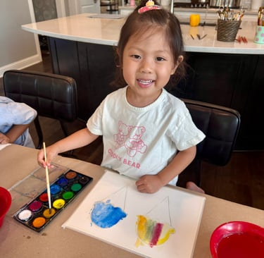Young girl painting with watercolors at Kelley's Neighborhood Art