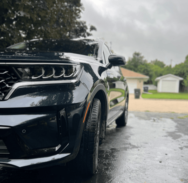 Perfectly washed sports car with sparkling clean windows and body