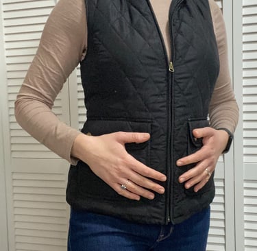 Woman holding stomach addressing hormone issues and fibroids