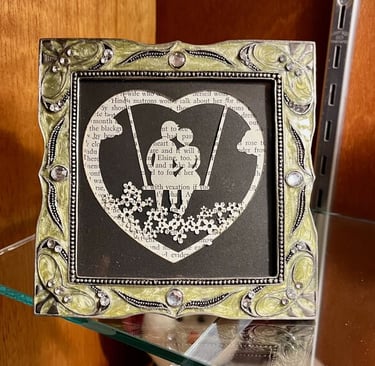 laser engraved layered paper silhouette of couple on a swing
