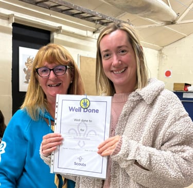 A certificate has been awarded by a beavers leader to Christine for painting the 25th Allerton Scout Hut 