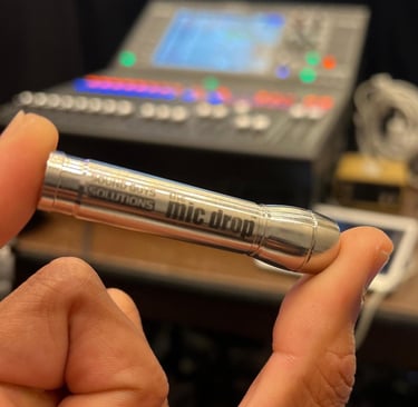 a person holding a lav mic drop in their hand