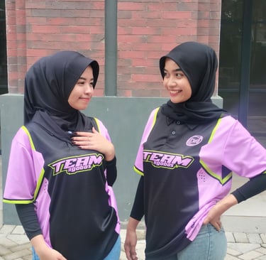 two women in hijab clothing standing next to each other
