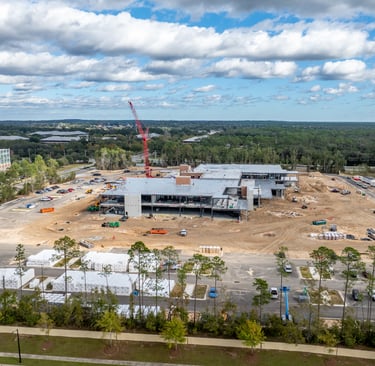 a large building with a crane in the foreground