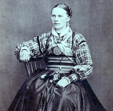 A black and white image circa 1890s of a woman in traditional dress