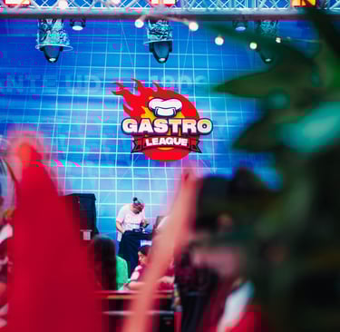 a man in a red suit and red shoes on stage