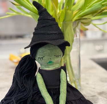 a stuffed toy of a green witch