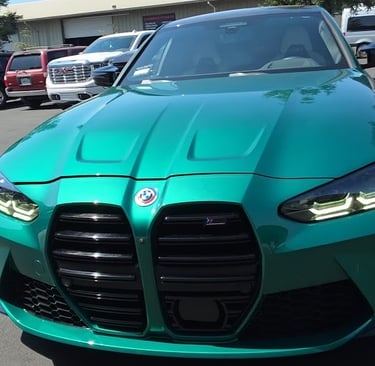 Close-up of a BMW M3's mirror-like finish after a Full Gloss Paint Protection Film (PPF) installatio
