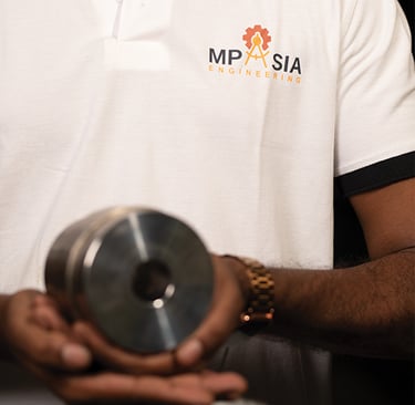 MP Asia Engineering Staff holding a CNC Precision Tool