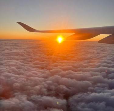 Airplane soaring above the clouds at sunset, capturing breathtaking sky views and travel adventure