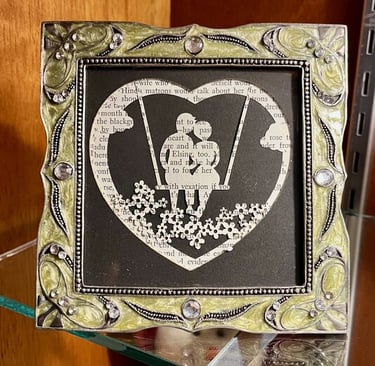 laser engraved layered paper silhouette of couple on a swing