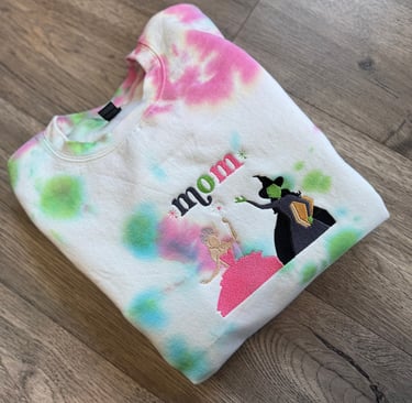 a white, pink and green tie dyed sweatshirt with the word "mom" embroidered on it