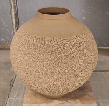 wheel-thrown moon jar with sodium silicate crack texture, waiting for bisque fire