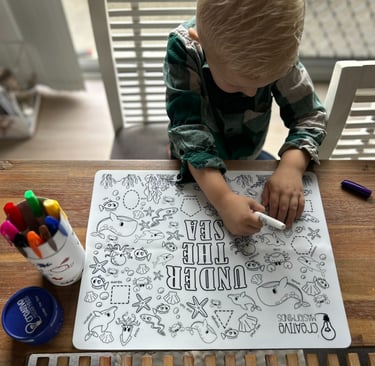 Toddler tracing sea animals on Scribbly Kids Under the Sea reusable drawing mat