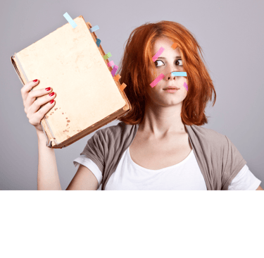 Photo of a woman holding a manuscript. Both the book and her face have colored sticky tabs on them