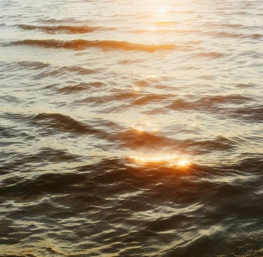 Vibrant sunset reflected on turbulent waters, symbolizing harmony found within life's contradictions