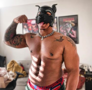 A man poses in a pup mask.