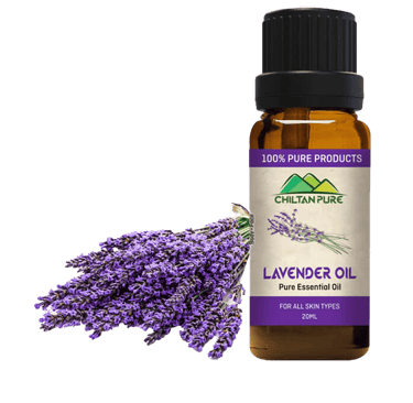 Purple Lavendar flowers next to Lavendar Essential Oil Bottle