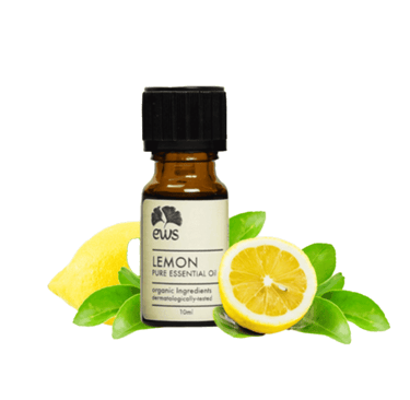 Fresh yellow cut lemon next to Lemon Essential Oil Bottle