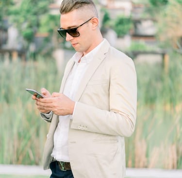 Francesco Margaretini Luxury Travel Villas Weddings working on the mobile phone