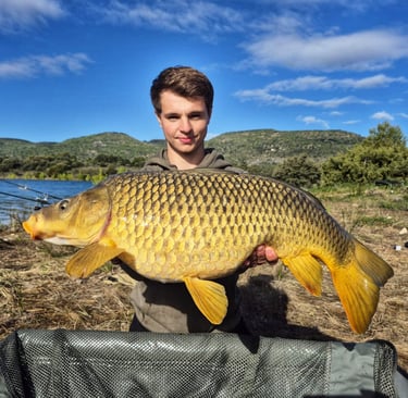 a man holding a fish carpel fish