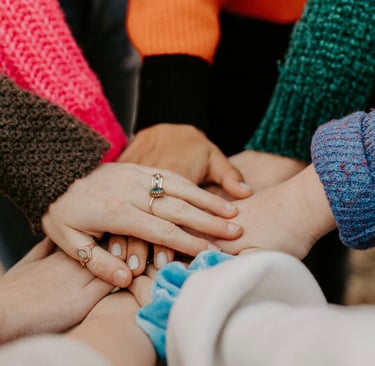 a group of people holding hands together