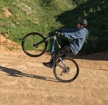 mountain biker in the balance point on a wheelie