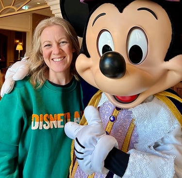 Leslie Hammer pictured with Mickey Mouse at Disneyland® Paris.