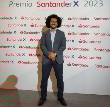 a man in a suit and tie standing in front of a sign that says,